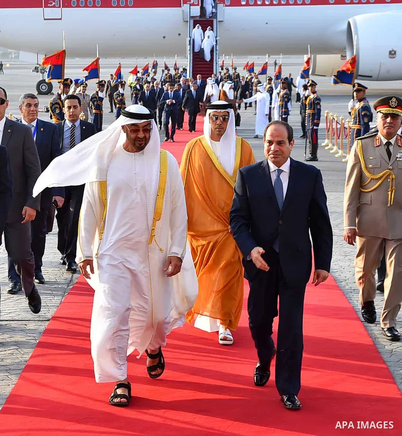 Egyptian President Abdel Fattah al-Sis walks with Abu Dhabi Crown Prince Sheikh Mohammed bin Zayed al-Nahyan after he arrives in Cairo International Airport on June 19, 2017. Photo by Egyptian President Office