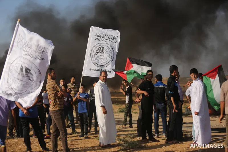 Palestinians react to tear gas fired by Israeli troops during clashes at a protest against reducing power supply to Gaza, near the border with Israel in Khan Younis in the southern Gaza Strip June 20, 2017. Photo by Ashr...