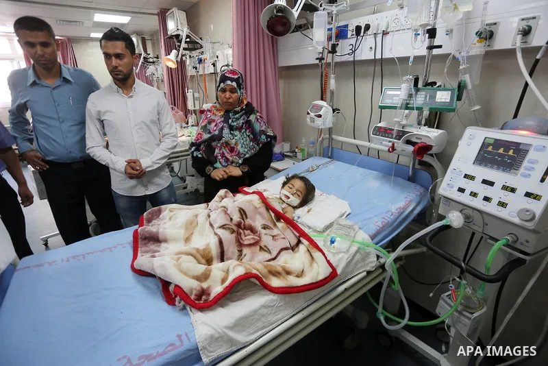 A Palestinian child with cancer receives treatment at the hospital in Gaza city on June 21, 2017. Photo by Mohammed Asad