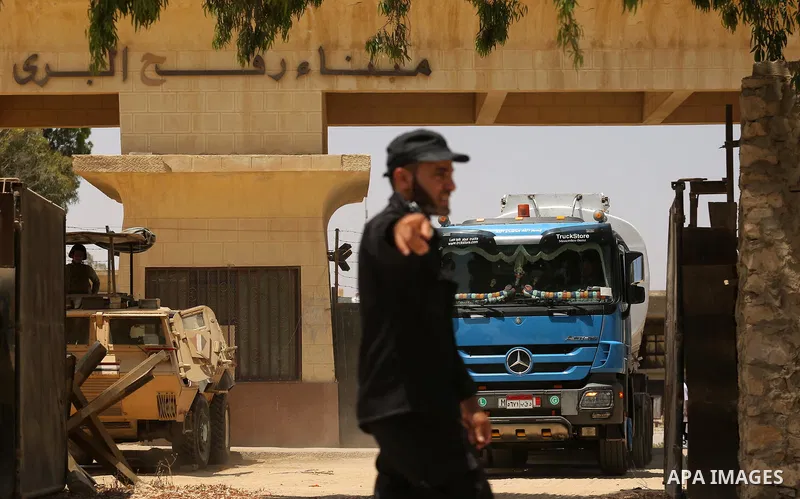 A member of Palestinian security forces stands guard as trucks carrying fuel enter the southern Gaza Strip from Egypt through the Rafah border crossing on June 21, 2017. Egypt began to deliver a million litres of fuel to...
