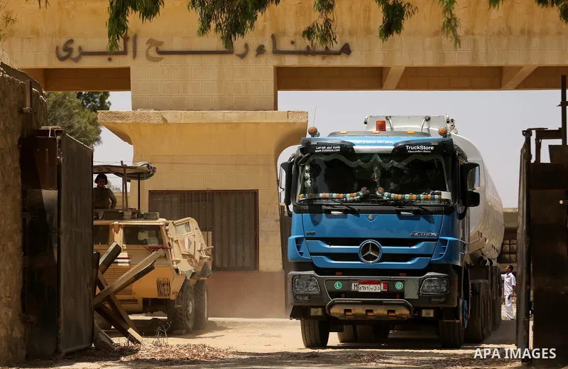A member of Egyprian security forces stands guard as trucks carrying fuel enter the southern Gaza Strip from Egypt through the Rafah border crossing on June 21, 2017. Egypt began to deliver a million litres of fuel to Ga...