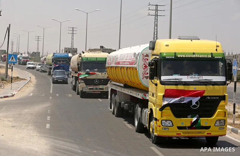 Egyptian trucks carrying fuel drive down a street after entering the southern Gaza Strip from Egypt through the Rafah border crossing on June 21, 2017. Egypt began to deliver a million litres of fuel to Gaza, a Palestini...