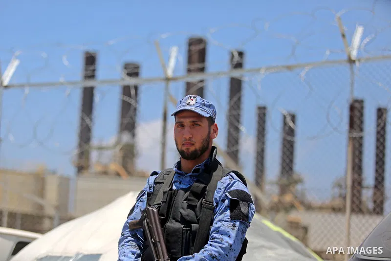 A member of Palestinian security forces stands guard as Egyptian trucks carrying fuel arrive to Gaza's power plant in Nusseirat, in the central Gaza Strip after entering the southern Gaza Strip from Egypt through the Raf...
