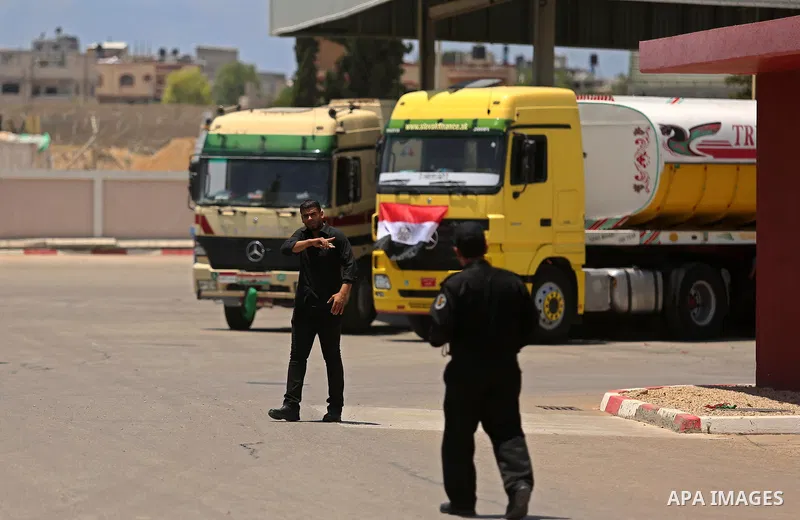 Palestinian security forces stand guards as Egyptian trucks carrying fuel arrive to Gaza's power plant in Nusseirat, in the central Gaza Strip after entering the southern Gaza Strip from Egypt through the Rafah border cr...