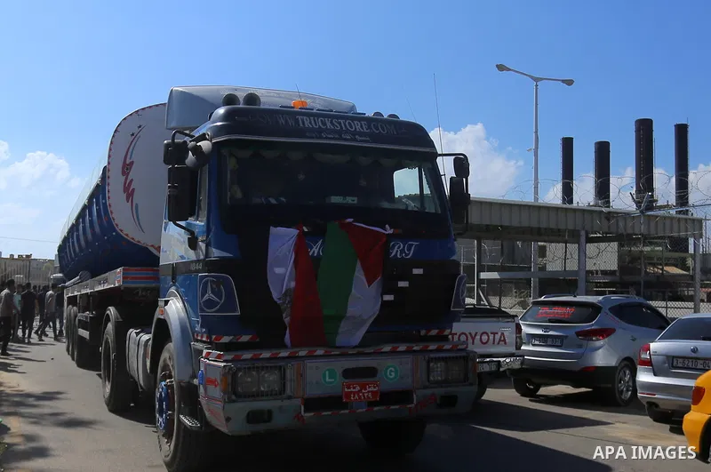 Palestinian policemen keep guard as tankers exit Gaza's power plant in Nuseirat in the center of Gaza strip on June 21, 2017. Egypt began to deliver a million litres of fuel to Gaza, temporarily easing a crisis that has...
