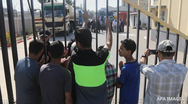 Palestinians hold banners during a protest against the worsening crisis of power outages in front of Gaza's power plant in Nuseirat in the center of Gaza strip, on June 21, 2017. Egypt began to deliver a million litres o...