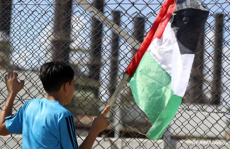 Palestinians hold banners during a protest against the worsening crisis of power outages in front of Gaza's power plant in Nuseirat in the center of Gaza strip, on June 21, 2017. Egypt began to deliver a million litres o...