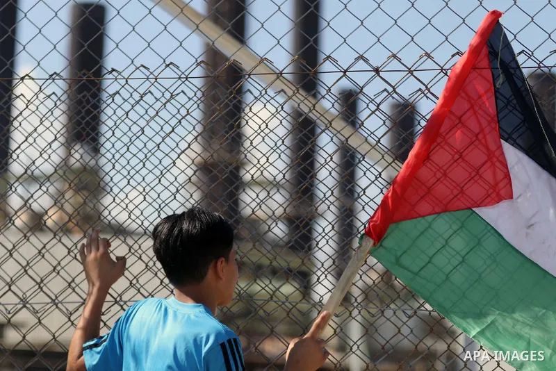 Palestinians hold banners during a protest against the worsening crisis of power outages in front of Gaza's power plant in Nuseirat in the center of Gaza strip, on June 21, 2017. Egypt began to deliver a million litres o...