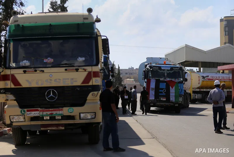 Palestinian policemen keep guard as tankers exit Gaza's power plant in Nuseirat in the center of Gaza strip on June 21, 2017. Egypt began to deliver a million litres of fuel to Gaza, temporarily easing a crisis that has...
