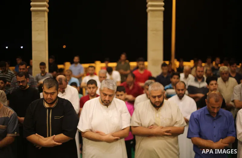 Palestinian Muslim worshippers pray overnight on July 22, 2017 at a Mosque in Gaza city on the occasion of Laylat al-Qadr which falls on the 27th day of the fasting month of Ramadan. Laylat al-Qadr, or Night of Destiny,...