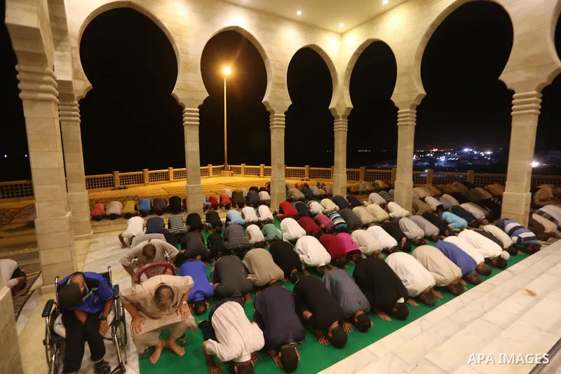 Palestinian Muslim worshippers pray overnight on July 22, 2017 at a Mosque in Gaza city on the occasion of Laylat al-Qadr which falls on the 27th day of the fasting month of Ramadan. Laylat al-Qadr, or Night of Destiny,...