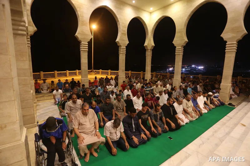 Palestinian Muslim worshippers pray overnight on July 22, 2017 at a Mosque in Gaza city on the occasion of Laylat al-Qadr which falls on the 27th day of the fasting month of Ramadan. Laylat al-Qadr, or Night of Destiny,...
