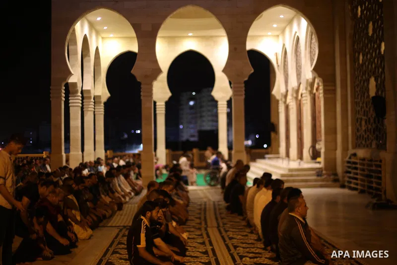 Palestinian Muslim worshippers pray overnight on July 22, 2017 at a Mosque in Gaza city on the occasion of Laylat al-Qadr which falls on the 27th day of the fasting month of Ramadan. Laylat al-Qadr, or Night of Destiny,...