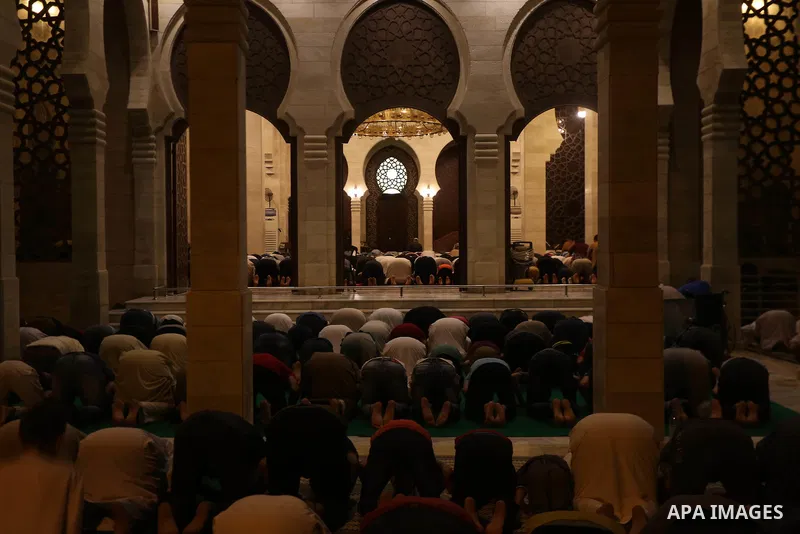 Palestinian Muslim worshippers pray overnight on July 22, 2017 at a Mosque in Gaza city on the occasion of Laylat al-Qadr which falls on the 27th day of the fasting month of Ramadan. Laylat al-Qadr, or Night of Destiny,...