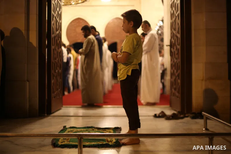 Palestinian Muslim worshippers pray overnight on July 22, 2017 at a Mosque in Gaza city on the occasion of Laylat al-Qadr which falls on the 27th day of the fasting month of Ramadan. Laylat al-Qadr, or Night of Destiny,...