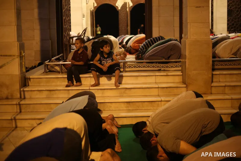 Palestinian Muslim worshippers pray overnight on July 22, 2017 at a Mosque in Gaza city on the occasion of Laylat al-Qadr which falls on the 27th day of the fasting month of Ramadan. Laylat al-Qadr, or Night of Destiny,...