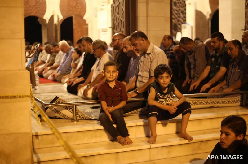 Palestinian Muslim worshippers pray overnight on July 22, 2017 at a Mosque in Gaza city on the occasion of Laylat al-Qadr which falls on the 27th day of the fasting month of Ramadan. Laylat al-Qadr, or Night of Destiny,...