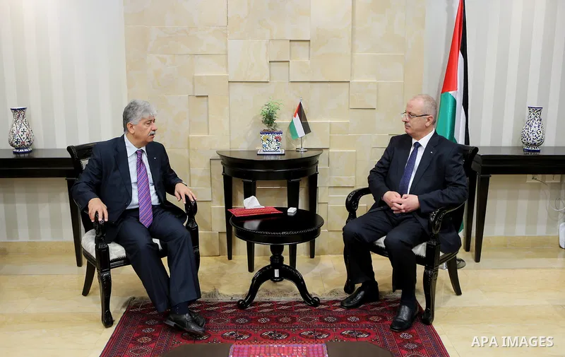 Palestinian Prime Minister Rami Hamdallah receives report of the Palestinian retirement Authority for 2016, at his office in the West Bank city of Ramallah on June 22, 2017. Photo by Prime Minister Office