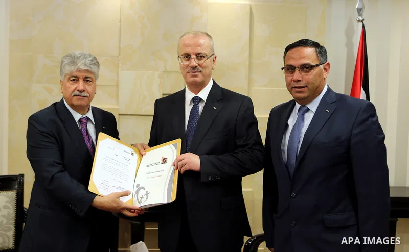 Palestinian Prime Minister Rami Hamdallah receives report of the Palestinian retirement Authority for 2016, at his office in the West Bank city of Ramallah on June 22, 2017. Photo by Prime Minister Office