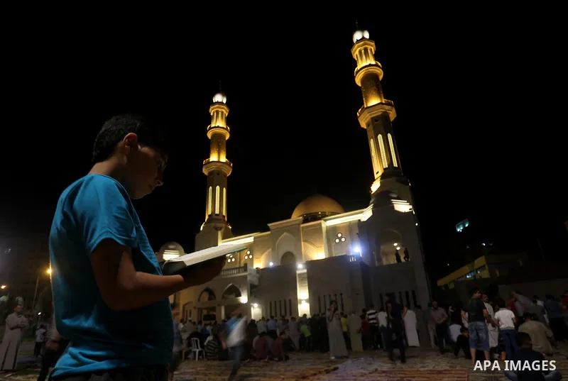 Palestinian Muslim worshippers pray overnight on July 22, 2017 at a Mosque in Gaza city on the occasion of Laylat al-Qadr which falls on the 27th day of the fasting month of Ramadan. Laylat al-Qadr, or Night of Destiny,...