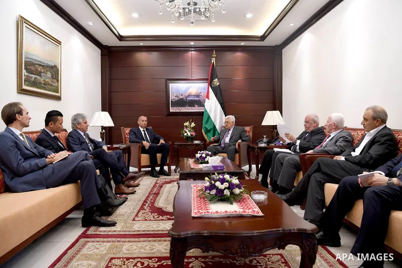Palestinian President Mahmoud Abbas receives the annual report of the Retirement Authority, in the West Bank city of Ramallah, on June 22, 2017. Photo by Osama Falah