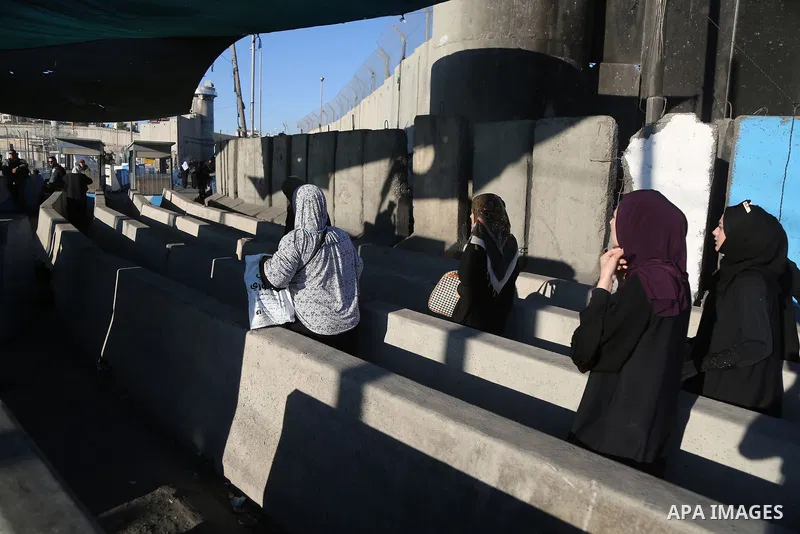 Palestinians going to pray at the al-Aqsa mosque compound in Jerusalem make their way through the Israeli Qalandia checkpoint, in the occupied West Bank between Ramallah and Jerusalem, during the last Friday of the holy...