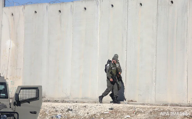 Israeli border police patrol as Palestinians going to pray at the al-Aqsa mosque compound in Jerusalem make their way through the Israeli Qalandia checkpoint, in the occupied West Bank between Ramallah and Jerusalem, dur...