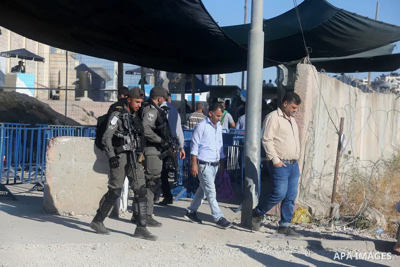 Palestinians going to pray at the al-Aqsa mosque compound in Jerusalem make their way through the Israeli Qalandia checkpoint, in the occupied West Bank between Ramallah and Jerusalem, during the last Friday of the holy...
