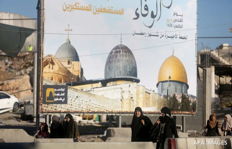 Palestinians going to pray at the al-Aqsa mosque compound in Jerusalem make their way through the Israeli Qalandia checkpoint, in the occupied West Bank between Ramallah and Jerusalem, during the last Friday of the holy...