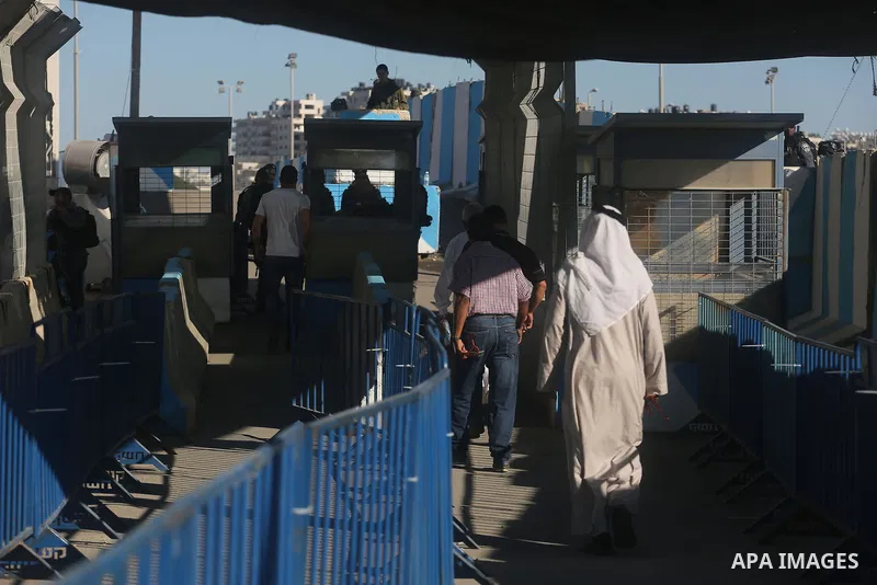 Palestinians going to pray at the al-Aqsa mosque compound in Jerusalem make their way through the Israeli Qalandia checkpoint, in the occupied West Bank between Ramallah and Jerusalem, during the last Friday of the holy...
