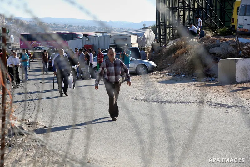 Palestinians going to pray at the al-Aqsa mosque compound in Jerusalem make their way through the Israeli Qalandia checkpoint, in the occupied West Bank between Ramallah and Jerusalem, during the last Friday of the holy...