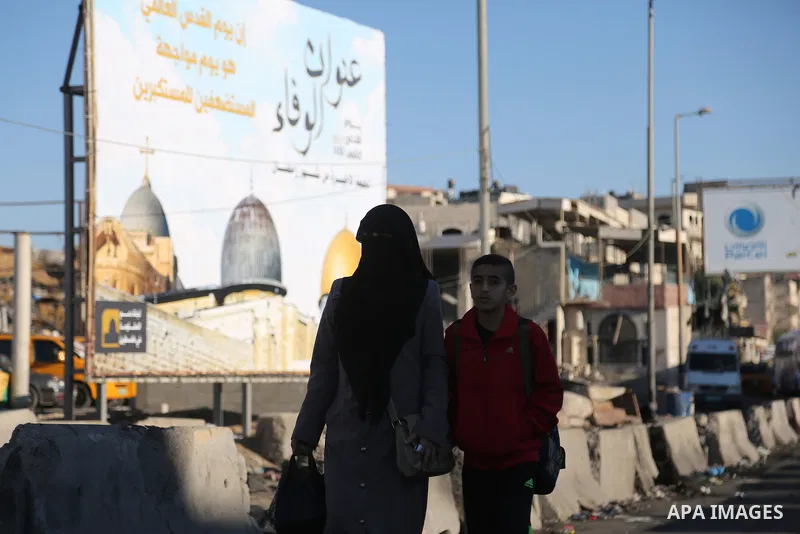 Palestinians going to pray at the al-Aqsa mosque compound in Jerusalem make their way through the Israeli Qalandia checkpoint, in the occupied West Bank between Ramallah and Jerusalem, during the last Friday of the holy...