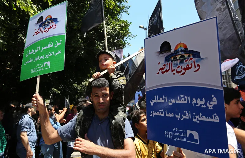 Palestinians take part in a protest marking the annual al-Quds Day, or Jerusalem Day, following Friday prayer in Gaza city June 23, 2017. Photo by Ashraf Amra