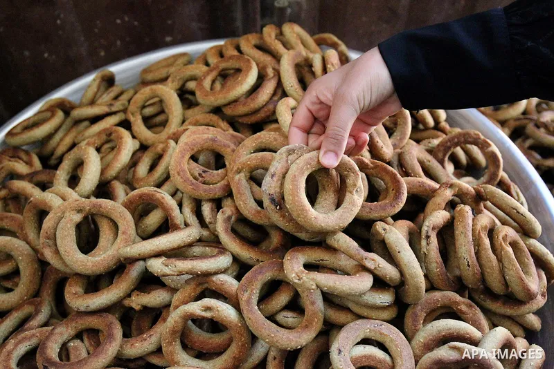 A Palestinian family make traditional date-filled cookies in preparation for the Eid al-Fitr holiday at their home in Rafah, in the southern Gaza Strip, on June 23, 2017. Muslims around the world are preparing to celebra...