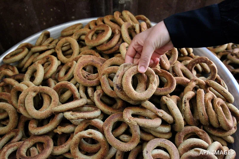 A Palestinian family make traditional date-filled cookies in preparation for the Eid al-Fitr holiday at their home in Rafah, in the southern Gaza Strip, on June 23, 2017. Muslims around the world are preparing to celebra...