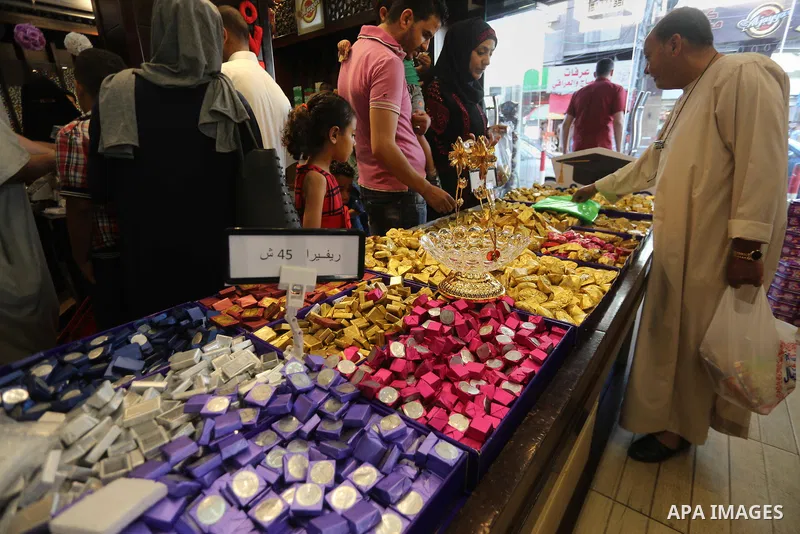 Palestinians sell chocolate at a shop ahead of the Eid al-Fitr holiday, in Gaza city, on JUne 23, 2017. Eid al-Fitr marks the end of Muslim's holy fasting month of Ramadan when faithfuls abstain from eating, drinking, sm...