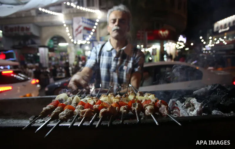 Palestinians shop at a market a few days ahead of Eid al-Fitr holiday, in the West Bank city of Nablus on June 23, 2017. Eid al-Fitr marks the end of Muslim's holy fasting month of Ramadan when faithfuls abstain from eat...
