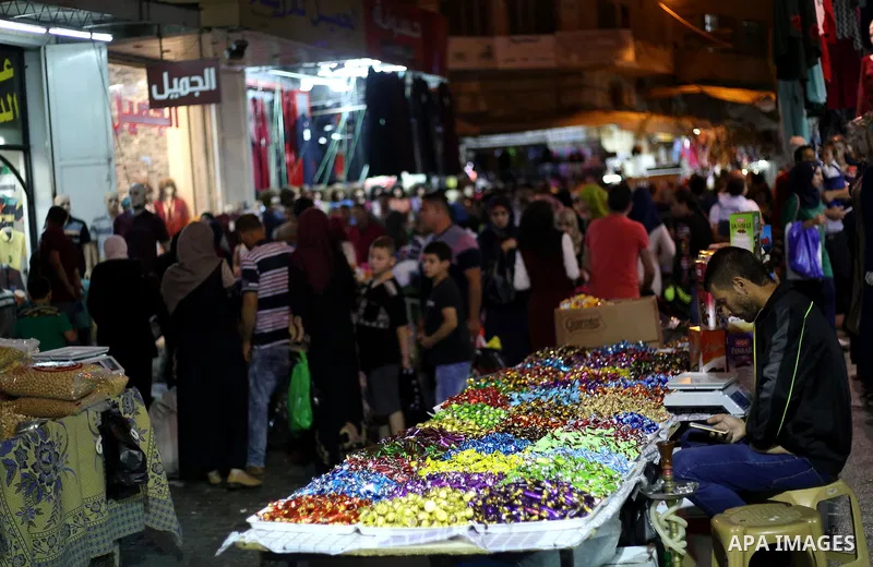 Palestinians shop at a market a few days ahead of Eid al-Fitr holiday, in the West Bank city of Nablus on June 23, 2017. Eid al-Fitr marks the end of Muslim's holy fasting month of Ramadan when faithfuls abstain from eat...