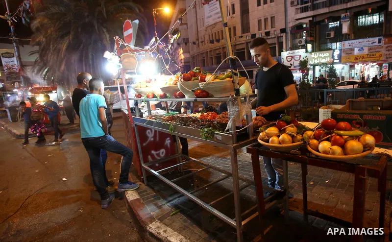Palestinians shop at a market a few days ahead of Eid al-Fitr holiday, in the West Bank city of Nablus on June 23, 2017. Eid al-Fitr marks the end of Muslim's holy fasting month of Ramadan when faithfuls abstain from eat...