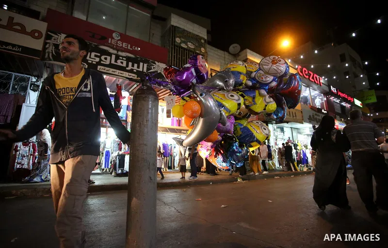Palestinians shop at a market a few days ahead of Eid al-Fitr holiday, in the West Bank city of Nablus on June 23, 2017. Eid al-Fitr marks the end of Muslim's holy fasting month of Ramadan when faithfuls abstain from eat...