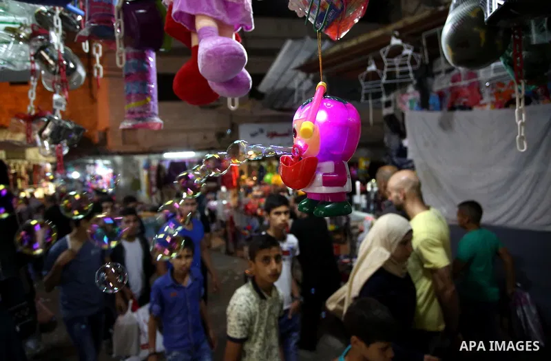 Palestinians shop at a market a few days ahead of Eid al-Fitr holiday, in the West Bank city of Nablus on June 23, 2017. Eid al-Fitr marks the end of Muslim's holy fasting month of Ramadan when faithfuls abstain from eat...