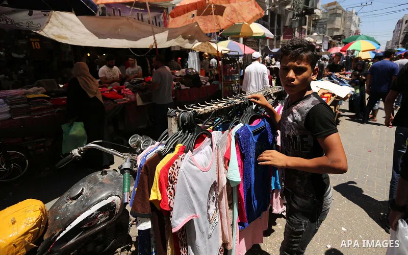Palestinians shop at a market ahead of Eid al-Fitr holiday, in Gaza city on June 24, 2017. Eid al-Fitr marks the end of Muslim's holy fasting month of Ramadan when faithfuls abstain from eating, drinking, smoking and sex...