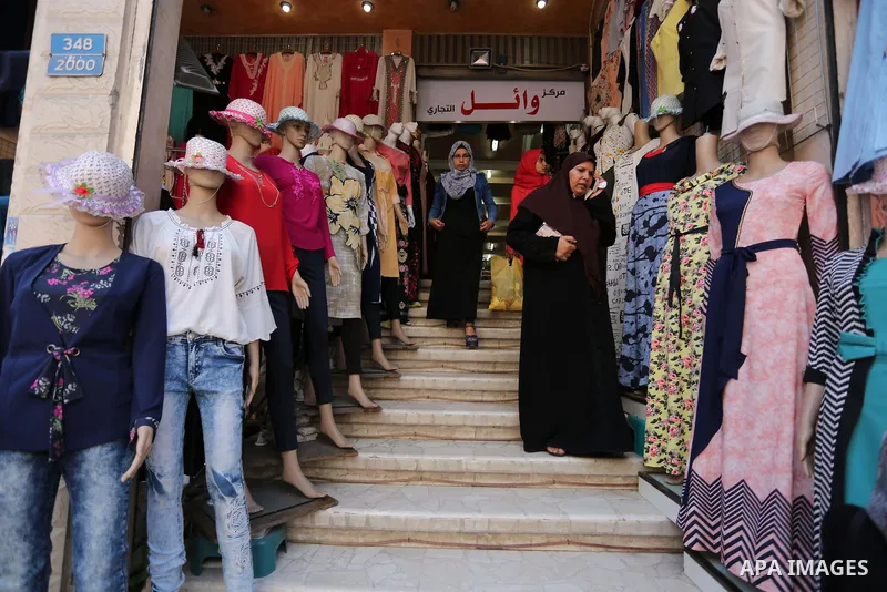 Palestinians shop at a market ahead of Eid al-Fitr holiday, in Gaza city on June 24, 2017. Eid al-Fitr marks the end of Muslim's holy fasting month of Ramadan when faithfuls abstain from eating, drinking, smoking and sex...