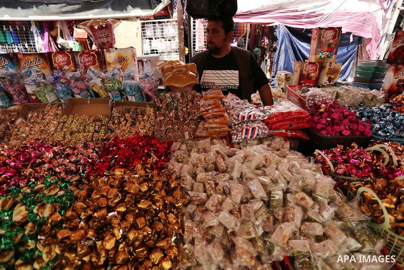 A Palestinian vendor sells chocolate at a market ahead of Eid al-Fitr holiday, in Gaza city on June 24, 2017. Eid al-Fitr marks the end of Muslim's holy fasting month of Ramadan when faithfuls abstain from eating, drinki...