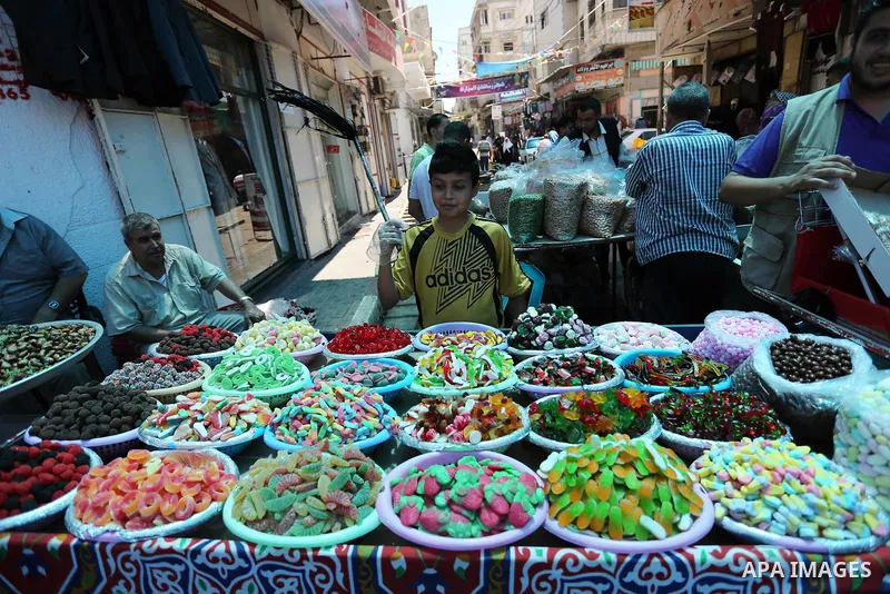 Palestinians shop at a market ahead of Eid al-Fitr holiday, in Gaza city on June 24, 2017. Eid al-Fitr marks the end of Muslim's holy fasting month of Ramadan when faithfuls abstain from eating, drinking, smoking and sex...