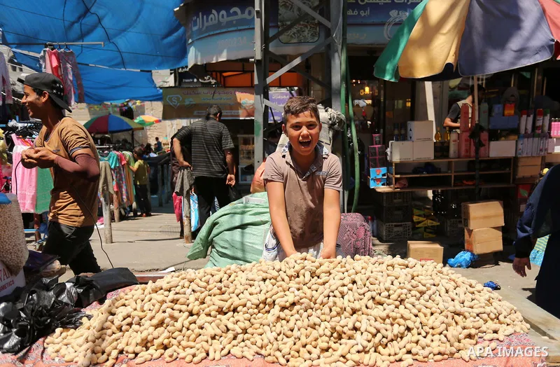 A Palestinian vendor sells nuts at a market ahead of Eid al-Fitr holiday, in Gaza city on June 24, 2017. Eid al-Fitr marks the end of Muslim's holy fasting month of Ramadan when faithfuls abstain from eating, drinking, s...