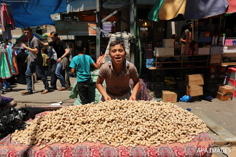 A Palestinian vendor sells nuts at a market ahead of Eid al-Fitr holiday, in Gaza city on June 24, 2017. Eid al-Fitr marks the end of Muslim's holy fasting month of Ramadan when faithfuls abstain from eating, drinking, s...