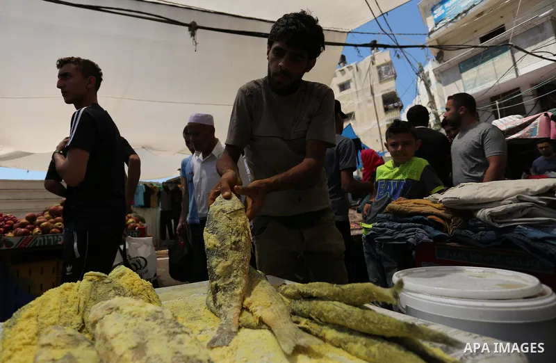 A Palestinian vendor sells salted fish at a market ahead of Eid al-Fitr holiday, in Gaza city on June 24, 2017. Eid al-Fitr marks the end of Muslim's holy fasting month of Ramadan when faithfuls abstain from eating, drin...