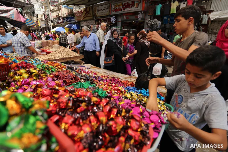 A Palestinian vendor sells chocolate at a market ahead of Eid al-Fitr holiday, in Gaza city on June 24, 2017. Eid al-Fitr marks the end of Muslim's holy fasting month of Ramadan when faithfuls abstain from eating, drinki...