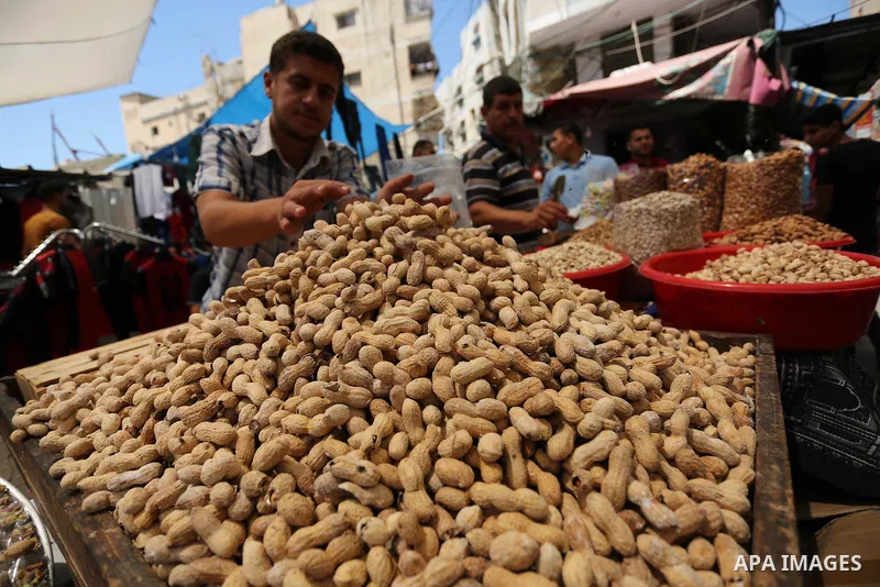 A Palestinian vendor sells nuts at a market ahead of Eid al-Fitr holiday, in Gaza city on June 24, 2017. Eid al-Fitr marks the end of Muslim's holy fasting month of Ramadan when faithfuls abstain from eating, drinking, s...